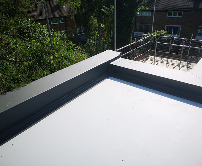rooftop view with a flat gray surface overlooking greenery and surrounding buildings featuring construction elements near the edge with a clear sky highlighting the modern architectural style ideal for 11 themed projects