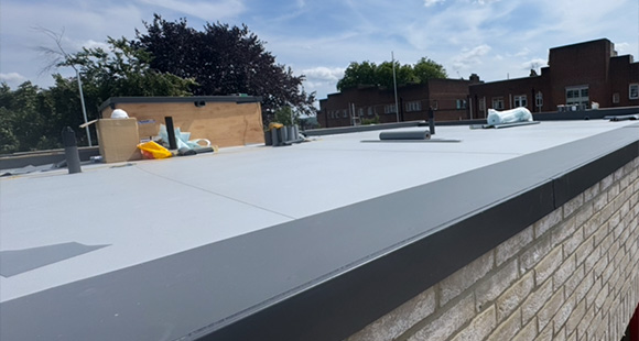flat roof surface showing tools and materials against a cloudy sky ideal for 8 roofing projects and repairs