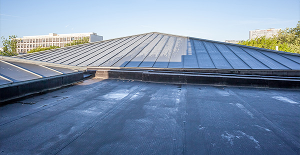 roofing installation with six visible angles and clear sky above